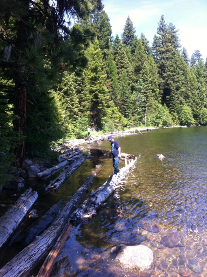 Student walks on log at Huckleberry Bay